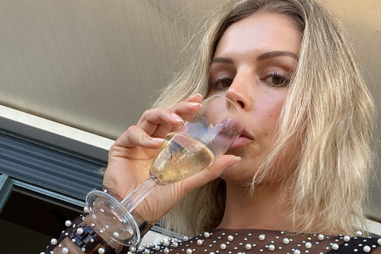 Person drinking sparkling wine